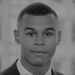 A photo portrait of Leon Johnson in black and white. He is wearing a suit and shirt.